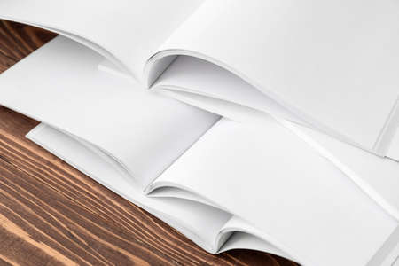 Open blank magazines on wooden table