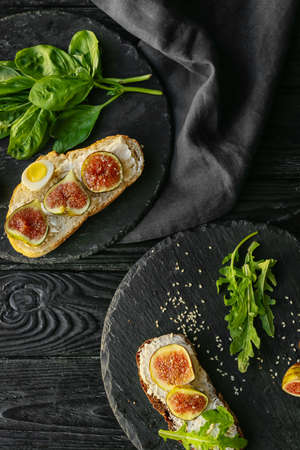 Tasty sandwiches with fig on dark wooden backgroundの写真素材