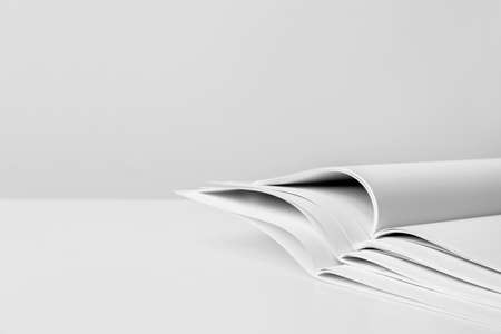 Open blank magazines on light background