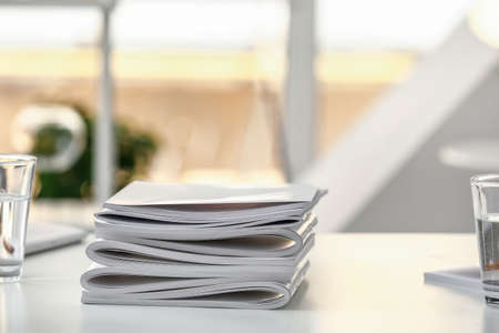 Stack of blank magazines on tableの写真素材