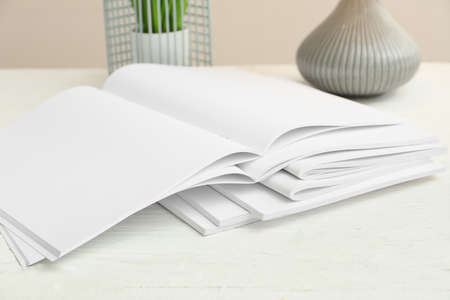 Open blank magazines on table