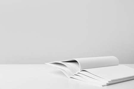 Open blank magazines on light background