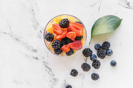 Bowl with fruit salad on light backgroundの写真素材