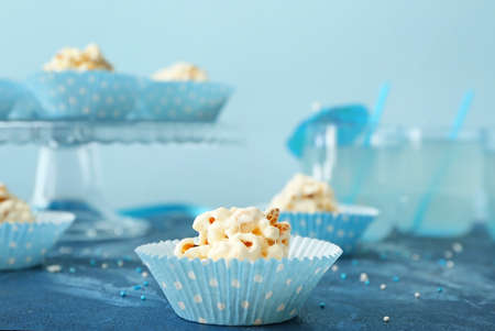 Tasty popcorn balls on color background