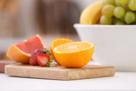 Board with different fruits on table