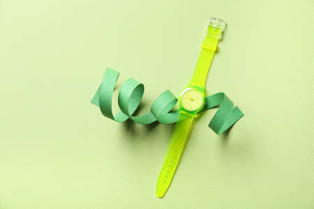 Stylish wrist watch on color background