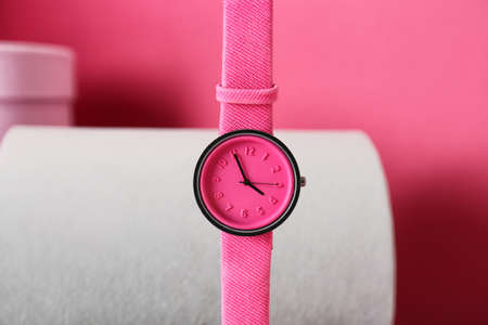 Stylish wrist watch on color background