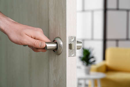 Man opening door at home