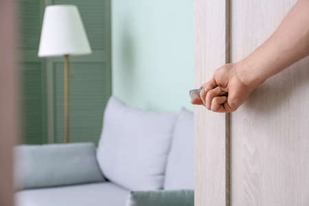 Man opening door at homeの写真素材