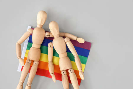 Wooden mannequins and lgbt flag on gray backgroundの写真素材