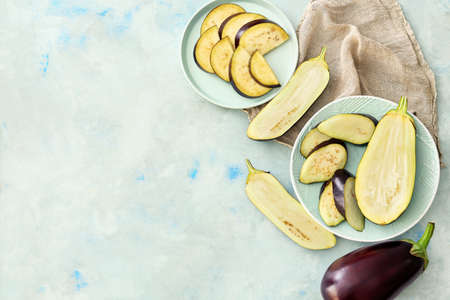 Plates with sliced eggplants on light backgroundの写真素材