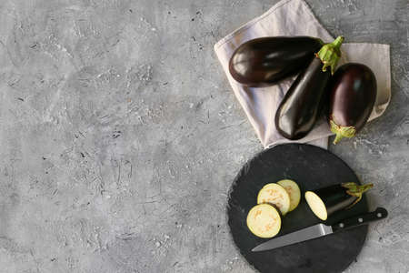 Board with sliced eggplant on grunge backgroundの写真素材