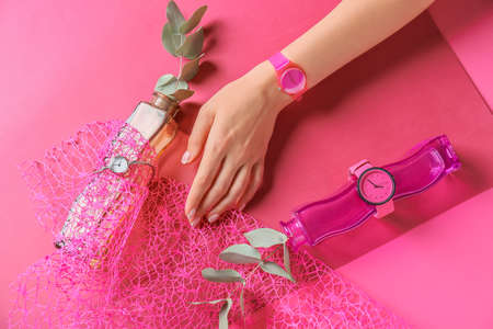 Composition with female hand and stylish wrist watches on color backgroundの写真素材