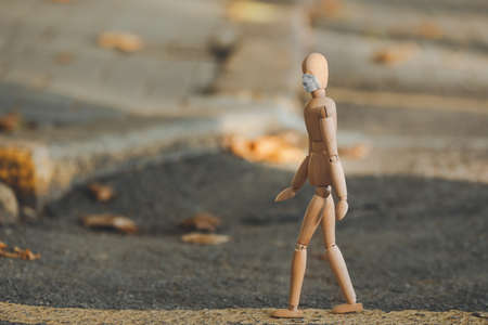 Wooden mannequin wearing medical mask outdoorsの写真素材