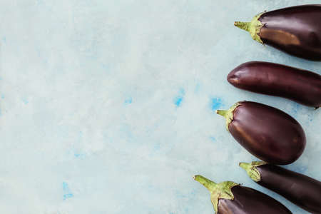 Fresh eggplants on light backgroundの写真素材