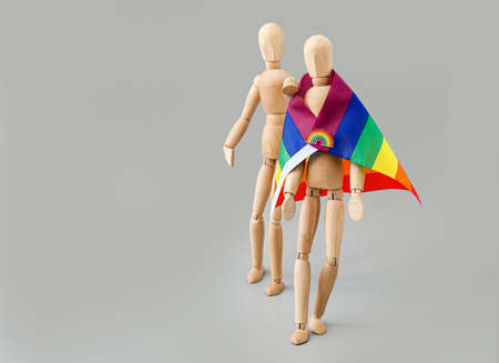 Wooden mannequins with rainbow flag on light backgroundの写真素材