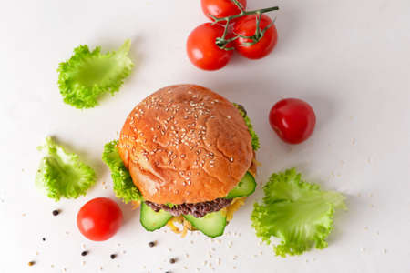 Tasty burger and ingredients on white backgroundの写真素材