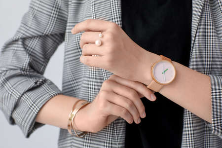 Woman with stylish wrist watch on white background