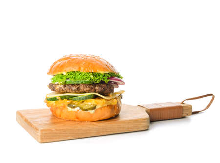 Wooden board with tasty burger on white backgroundの写真素材