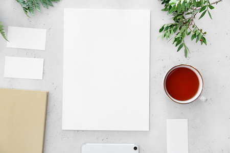 Blank magazine and cup of tea on light backgroundの写真素材
