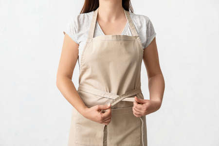 Female waiter wearing apron on white backgroundの写真素材