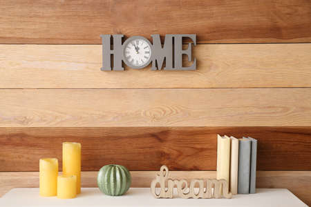 Table with decor near wooden wallの写真素材