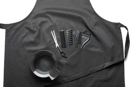 Apron and set of hairdresser's supplies on white backgroundの写真素材