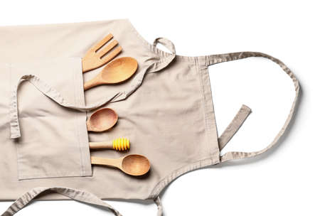 Apron and eco cutlery on white backgroundの写真素材