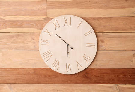 Modern clock hanging on wall