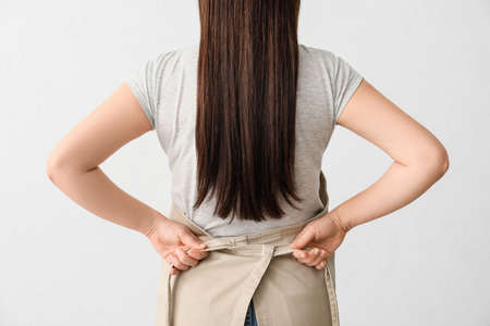 Female waiter wearing apron on white backgroundの写真素材