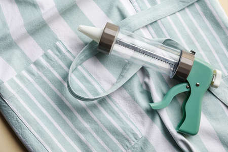 Apron and confectionery syringe as background