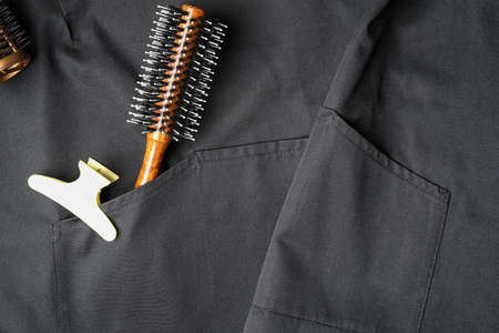 Hair clip, brush and apron as background