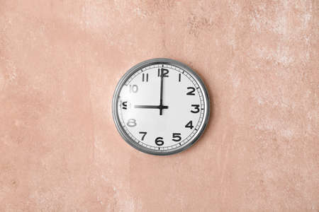 Modern clock hanging on wall