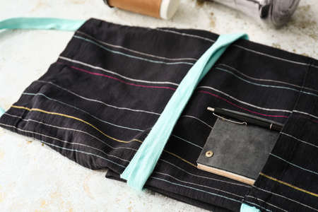 Apron, pen and notebook on tableの写真素材