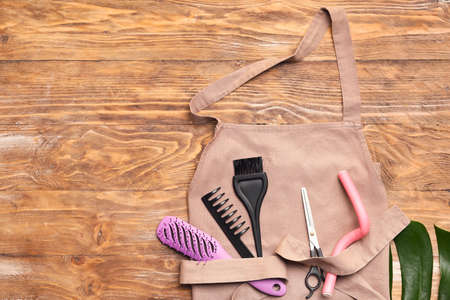 Composition with apron and hairdresser's supplies on wooden backgroundの写真素材