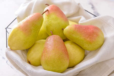 Fresh ripe pears on light background