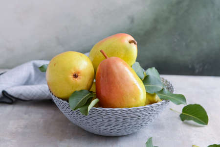 Composition with fresh pears on light background