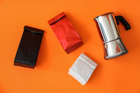 Blank bags with coffee pot on color backgroundの写真素材