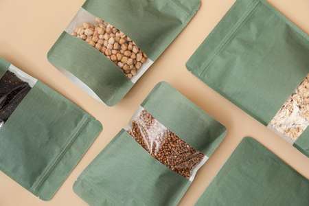 Bags with different groats on color background