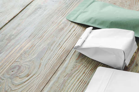 Blank bags on wooden background