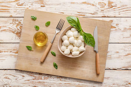Composition with mozzarella cheese on wooden background