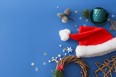 Christmas composition with Santa Claus hat on color backgroundの写真素材