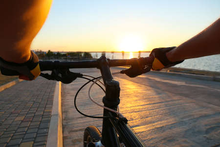 Male cyclist riding bicycle outdoors, closeupの写真素材