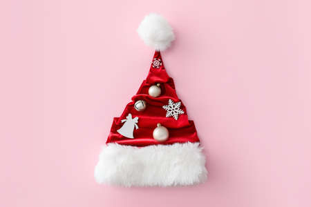 Santa Claus hat with Christmas decor on color backgroundの写真素材