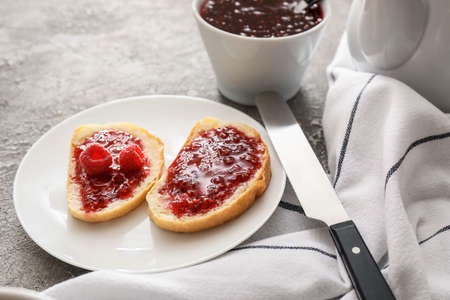 Toasts with sweet raspberry jam on grunge background