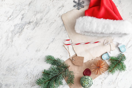 Santa hat and Christmas decor on light backgroundの写真素材