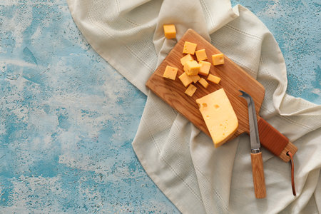 Tasty cut cheese on color backgroundの写真素材