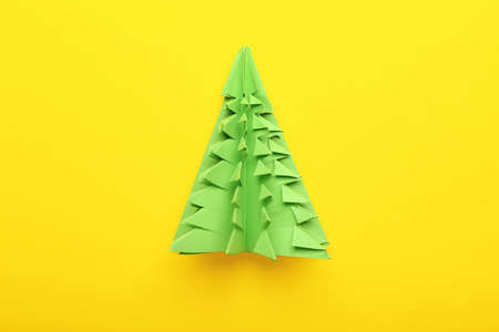 Beautiful Christmas tree made of paper on color background