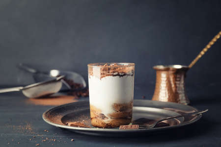 Tasty tiramisu on dark tableの写真素材