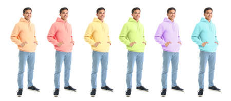 Young man wearing stylish hoodies in different colors on white backgroundの写真素材